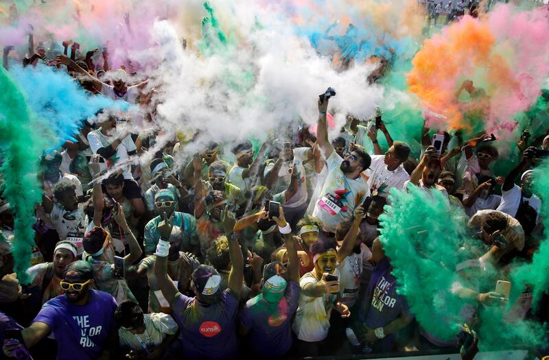 Participants throw colored powder into the air during the Colour Run, also known as the Happiest 5k on the Planet, in Jeddah, Saudi Arabia. AP Photo