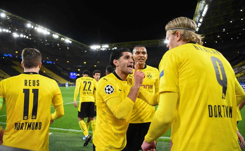 Dortmund's English midfielder Jude Bellingham (2nd L) celebrates scoring the opening goal. AFP