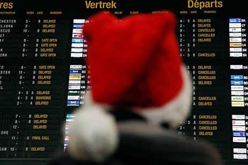 A departure board is filled with cancelled and delayed flight notifications at the Zaventem airport near Brussels.