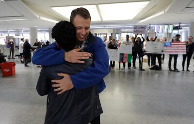 Army Capt. Matthew Ball, right, hugs his former interpreter Qismat Amin, as Amin arrives from Afghanistan, at San Francisco International Airport Wednesday, Feb. 8, 2017, in San Francisco. Ball welcomed Amin to the United States after buying him a plane ticket to ensure he would get in quickly amid concerns the Trump administration may expand its travel ban to Afghanistan. (AP Photo/Marcio Jose Sanchez)