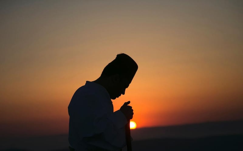 A Samaritan worshiper prays on top of Mount Gerizim near Nablus, West Bank as they celebrate the Shavuot festival at dawn.  Jaafar Ashtiyeh / AFP Photo