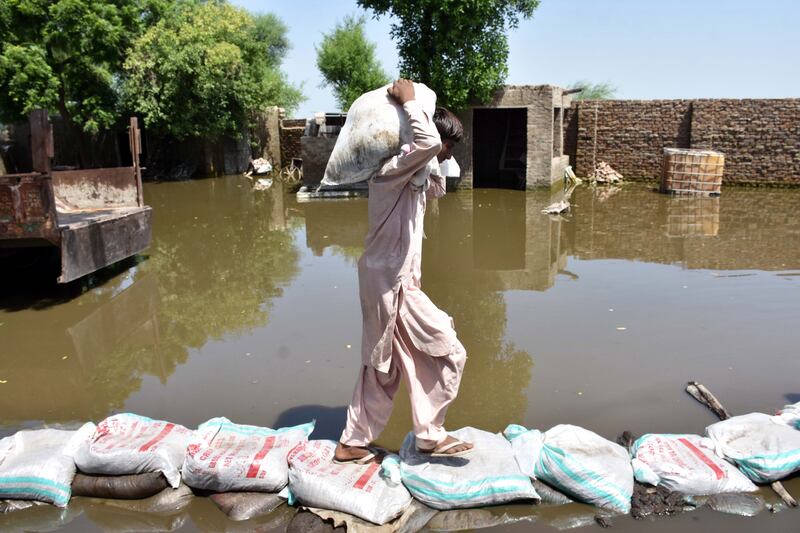 People affected by floods move to higher ground on the outskirts of Quetta, Balochistan Province. EPA