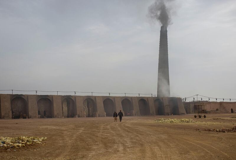 Smoke billows from a kiln chimney stack at the brickmaking factory. AFP