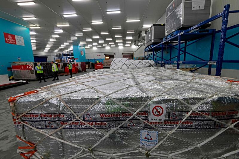 Airport personnel unload a coronavirus vaccine shipment at Dubai International Airport on February 1, 2021. AFP