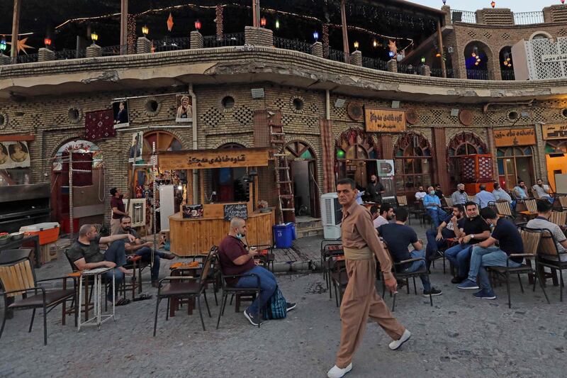 Iraqis sit at a coffee shop in front of Arbil Citadel.  AFP