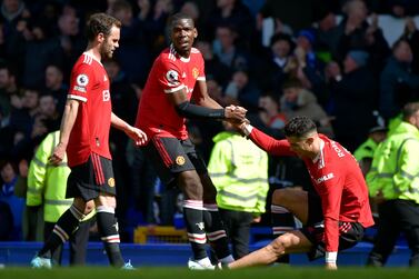 Manchester United's Paul Pogba helps teammate Cristiano Ronaldo get back on his feet at the end of the Premier League soccer match between Everton and Manchester United at Goodison Park, in Liverpool, England, Saturday, April 9, 2022.  Everton won 1-0.  (AP Photo / Rui Vieira)