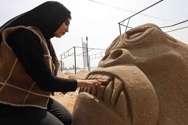 Omnia Raafat, a Fine Arts student at Matrouh University, works on her project "King Kong (Gorilla)", during the competition for the best sand sculptures, in the "Alexandria Sand Sculptures Festival", to promote tourism and mark the beginning of summer, at Al Saraya public beach in Egypt's coastal city of Alexandria, Egypt May 9, 2023.  REUTERS / Amr Abdallah Dalsh