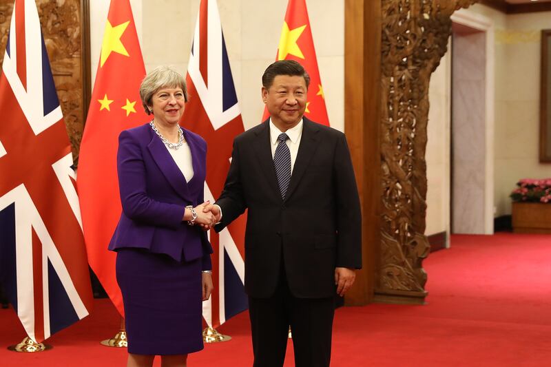 Ms May is greeted by Chinese President Xi Jinping in February 2018 in Beijing, China