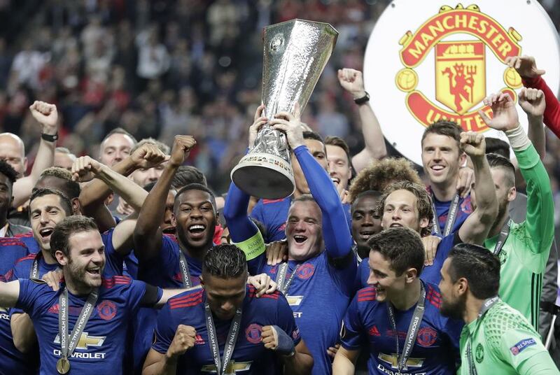Manchester United captain Wayne Rooney lifts the Europa League trophy. Michael Sohn / AP Photo