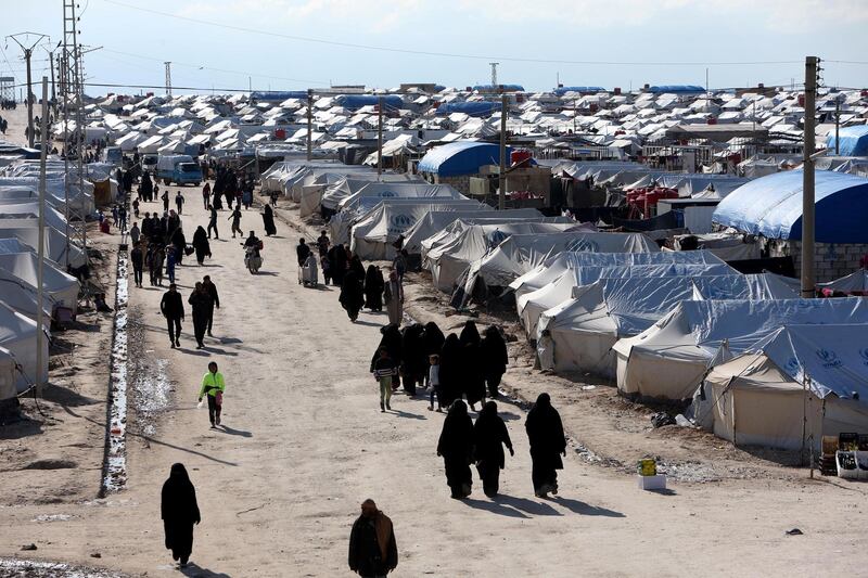 FILE PHOTO: Women walk through al-Hol displacement camp in Hasaka governorate, Syria April 1, 2019. REUTERS/Ali Hashisho/File Photo