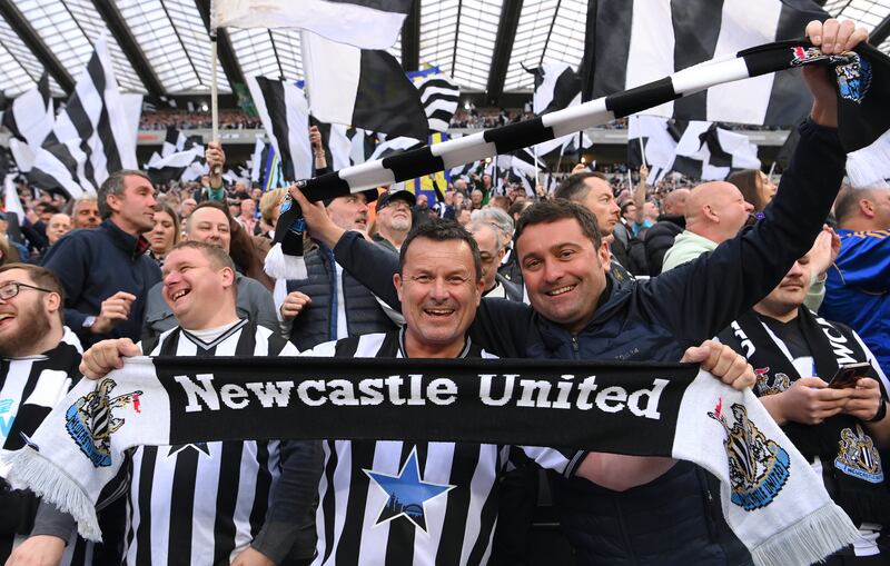 Newcastle fans wave scarves in the West Stand. Getty Images