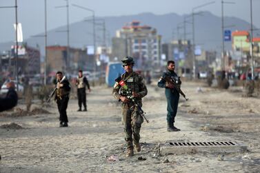Afghan security personnel gather at the site of bomb explosion in Kabul, Afghanistan, Wednesday, Feb. 26, 2020. AP