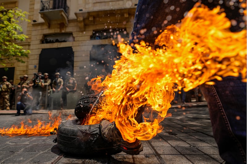 Tyres are set on fire in a protest against high street banks in Beirut. AP