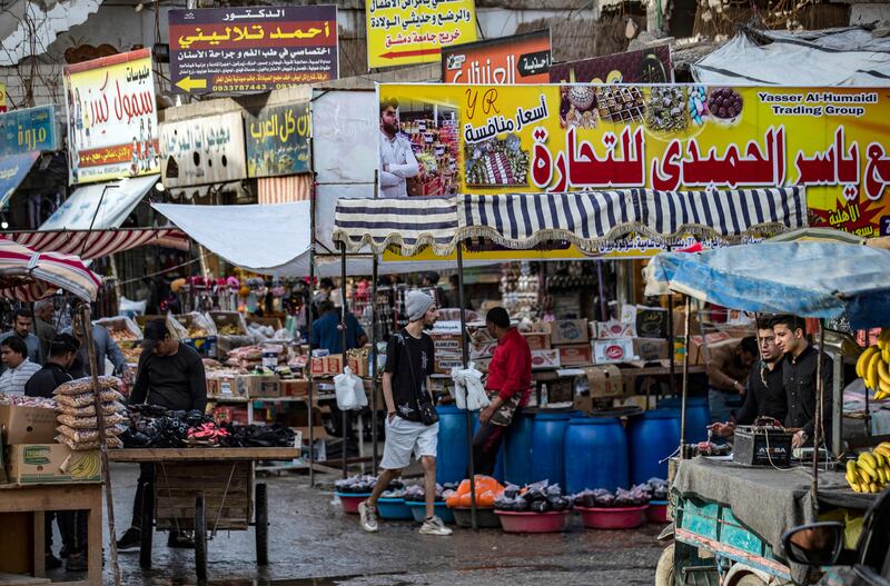 Syrians shop at a market in Raqa as Muslims prepare to celebrate Eid.  AFP