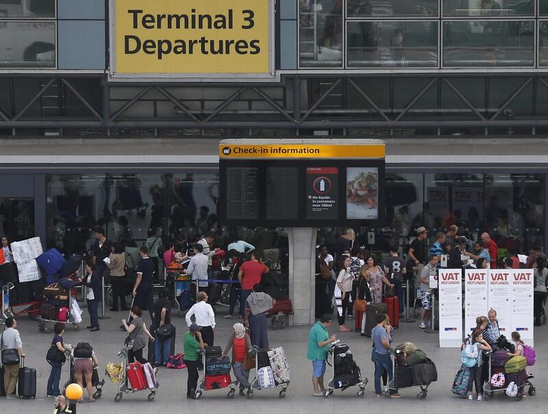 Passengers queue outside Terminal 3 at Heathrow Airport in London. Sang Tan / AP Photo