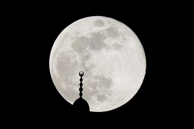 The full Moon rises over a mosque minaret in Amman, Jordan. Reuters
