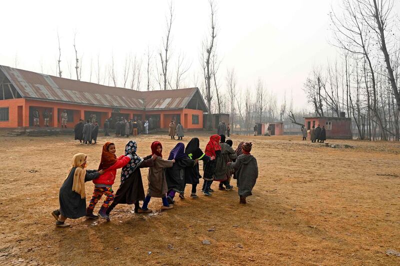 Children play inside a polling station during the second phase of the District Development Council and Panchayat by-elections in Najan Sumbal area of Bandipora district. AFP