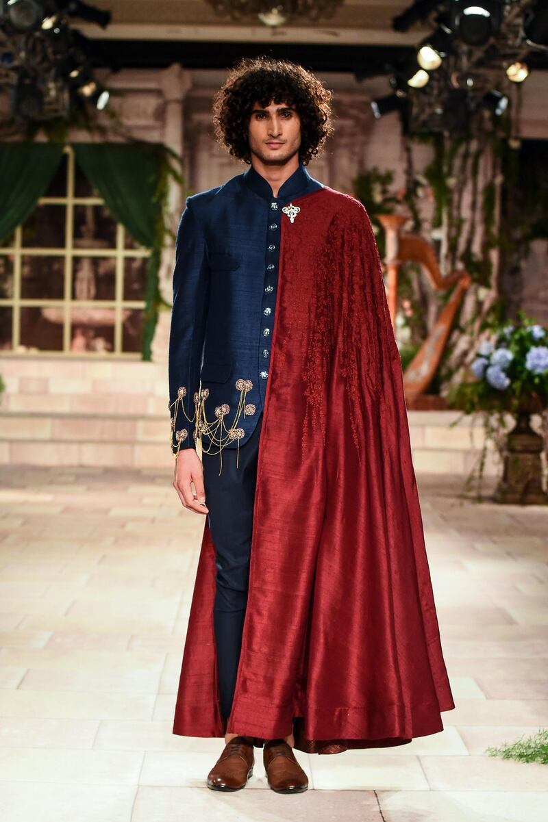 Designer Anju Modi reinterpreted the traditional dupatta as a superhero cape in her menswear line. AFP