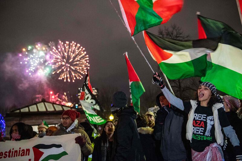 New Year's Eve fireworks go off in the sky as pro-Palestinian supporters protest in Boston, Massachusetts. AFP