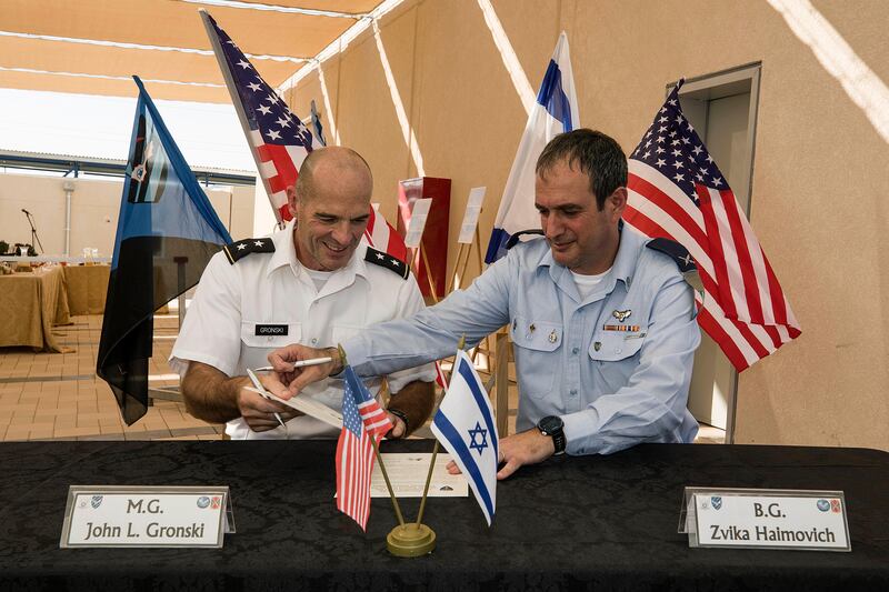 Israeli Defense Forces Brig. Gen. Zvika Haimovich, right, and U.S. Maj. Gen. John L. Gronski sign an agreement during a ceremony at the Bislach Air Base, near Mitzpe Ramon, Monday, Sept. 18, 2017. Israel and the United States announced plans Monday to open the first American air base in the Jewish state -- a facility that will aim to bolster Israel's aerial defenses. (AP Photo/Tsafrir Abayov)