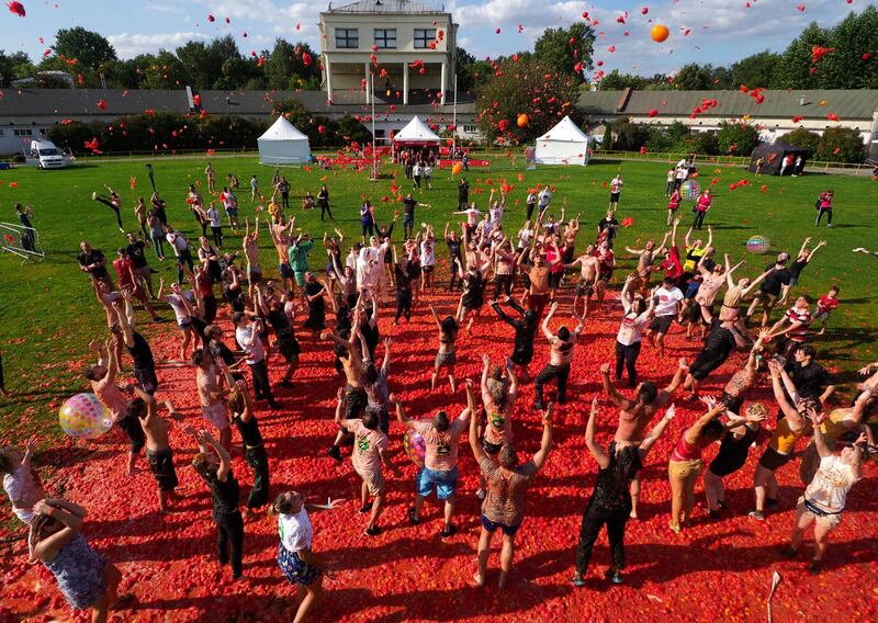 People throw tomatoes as they take part in the first Russian Tomatina battle in St.Petersburg, Russia.  AP