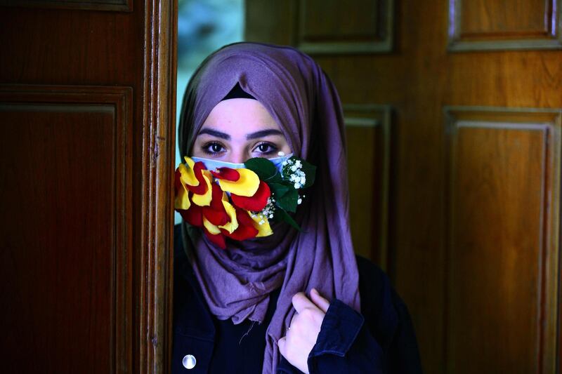 A woman is seen wearing a mask embellished with petals in the central Iraqi holy city of Najaf. AFP