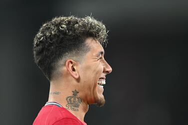 Liverpool's Brazilian midfielder Roberto Firmino celebrates after scoring his team second goal during the UEFA Champions League quarter final second leg football match between Liverpool and Benfica at the Anfield stadium, in Liverpool, on April 13, 2022.  (Photo by Paul ELLIS  /  AFP)