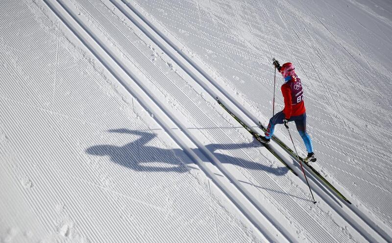 The sun casts the shadow of a cross-country skier during training at Laura Cross-country Ski & Biathlon Center in Krasnaya Polyana, Russia. Gero Breloer / AP