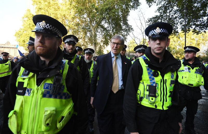 Brexiter and Member of Parliament, Bill Cash (C) leaves the Houses of Parliament escorted by police. EPA