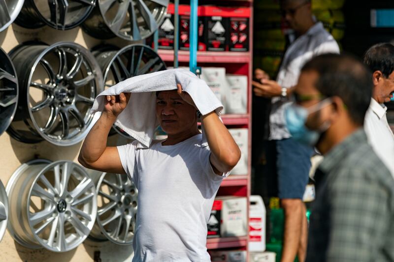 A man tries to beat the heat in Satwa, Dubai. Rainclouds could form over eastern parts of the Emirates on Thursday and Friday. Chris Whiteoak / The National