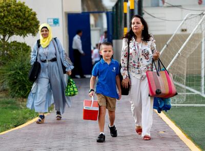 Abu Dhabi, U.A.E., September 2, 2018. 
 Pupils heading to school for the first day after the summer break at the Pearl Academy School on Muroor Road. - - Eben-6, year 2 with mother Maryke.
Contact: Victor Besa / The National
Section:  NA
Reporter:  Anam Rizvi