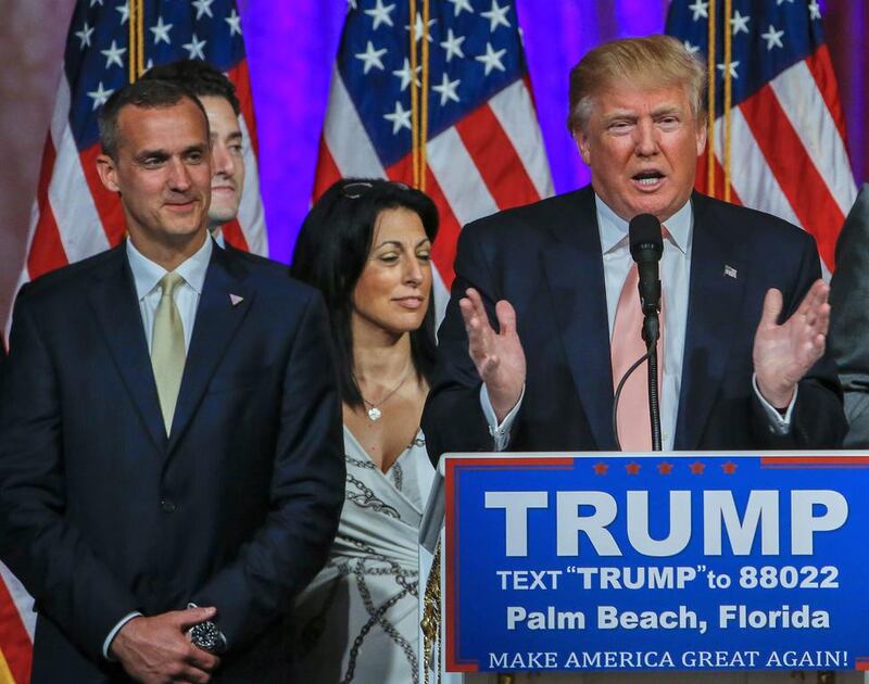 Republican presidential candidate Donald Trump's campaign manager, Corey Lewandowski (L), looks on as Mr Trump (C) speaks at an election campaign event in Palm Beach, Florida on March 15, 2016, after winning the state's Republican primary. Erik S Lesser/EPA