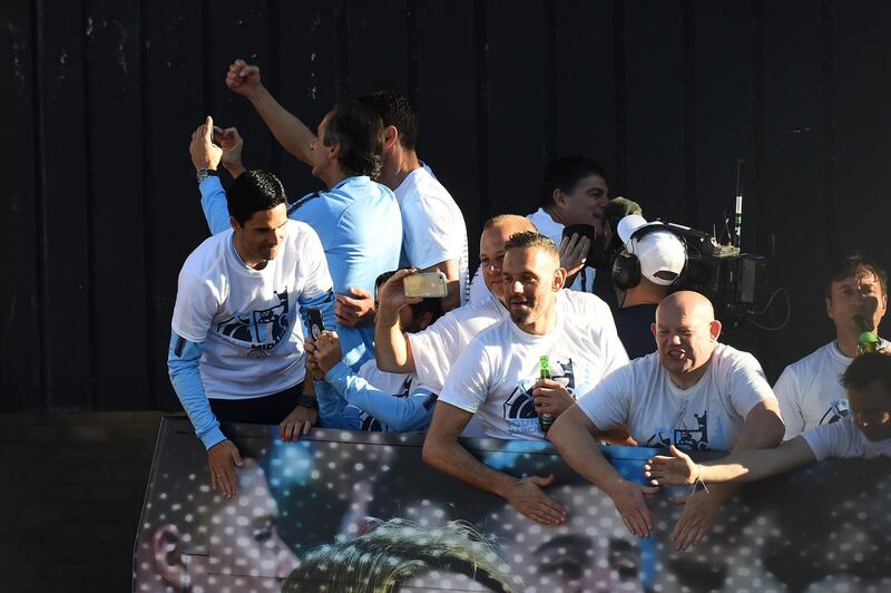 Manchester City backroom staff celebrates on the team bus during the Manchester City Teams Celebration Parade in Manchester, England. Getty Images