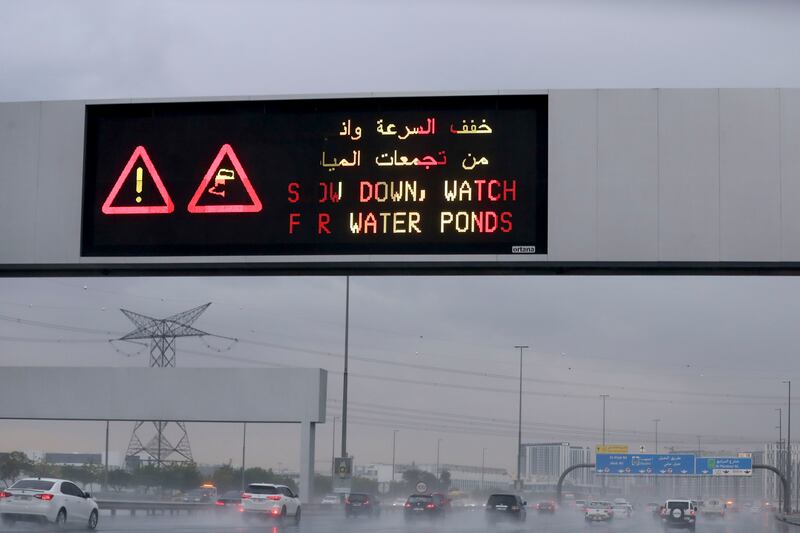 A road sign advises motorists to ‘Slow down, watch for water ponds’ on a highway in Dubai. Khushnum Bhandari / The National