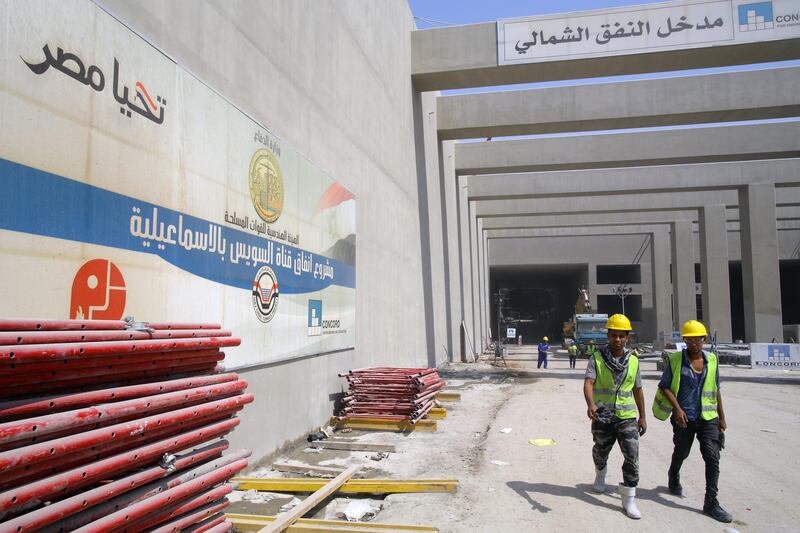 Labourers walk near the entrance to one of the new tunnels. EPA