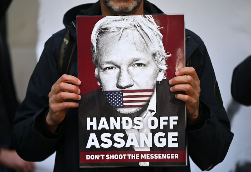 Supporters and activists hold placards outside Westminster Magistrates court in London in April calling for WikiLeaks founder Julian Assange to be freed.  AFP