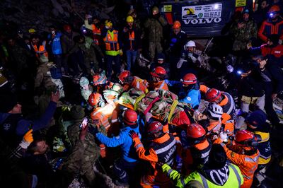 Rescuers carry Ece Koseoglu, 25, from the rubble of a collapsed building in Antakya, southern Turkey. AFP