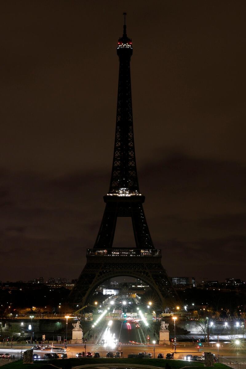 The Eiffel Tower goes dark in tribute to the victims. AFP