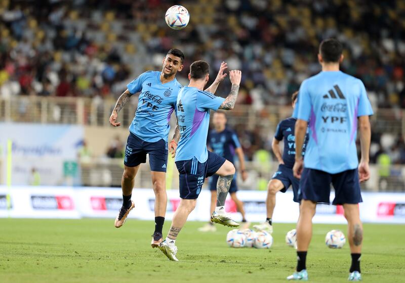 Argentina's Cristian Romero and Lionel Messi.