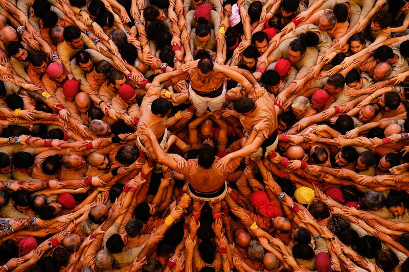 Members of the Colla Xiquets de Reus team form their castell, or human tower, during a castell contest final in Tarragona, Catalonia, Spain.  EPA