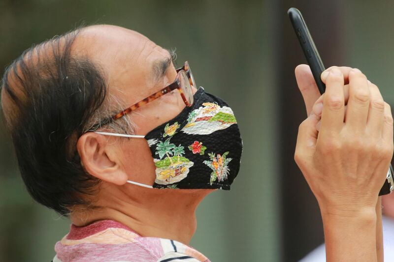 A man takes a pictures in Tokyo, Japan. AP Photo