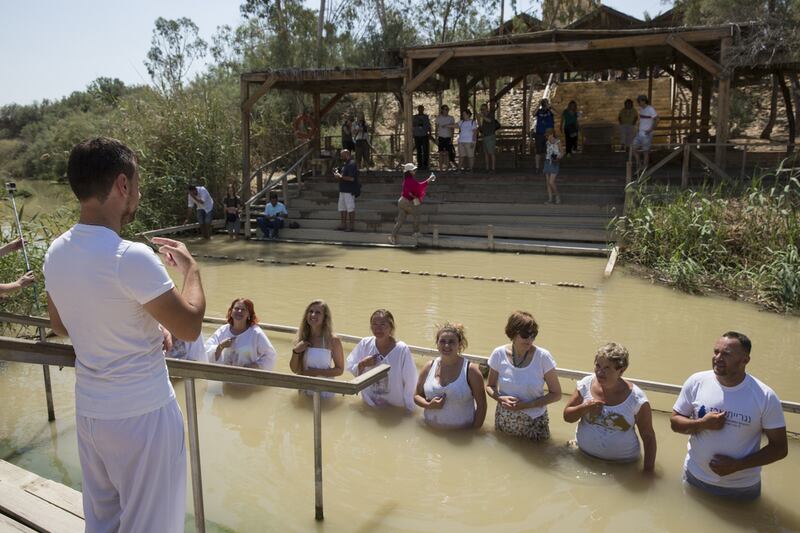 A group of deaf Russian immigrants use sign language as they hold a ceremony and visit the Jordan River  at the Qasr Al Yahud baptism site on the West Bank side of the river. Christian worshippers believe the site is where John the Baptist baptised Jesus is located. The Jordanian side of the river is seen in the background.