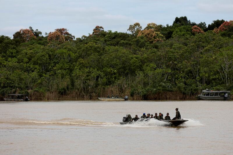Brazilian soldiers aboard a skiff during the search for British journalist Dom Phillips and indigenous expert Bruno Pereira, who went missing in a remote part of the Amazon rainforest, near the border with Peru, at Atalaia do Norte, Amazonas state. Reuters