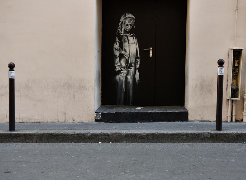 A recent artwork believed to be attributed to Banksy is of a woman veiled in mourning next to the Bataclan concert venue in Paris, France.   Banksy's mural located on the door to Bataclan concert hall, where 90 people have been killed in a terror attack in 2015, has been stolen.  EPA