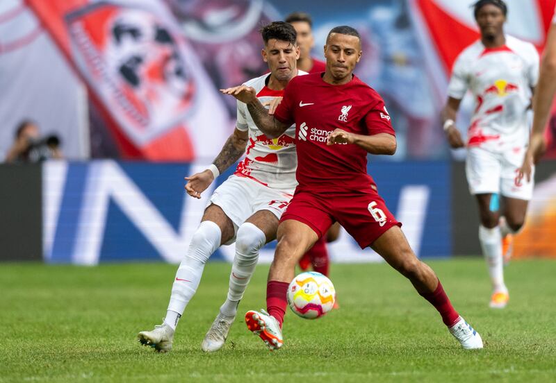 Leipzig's Dominik Szoboszlai and Thiago Alcantara of Liverpool fight for the ball. PA