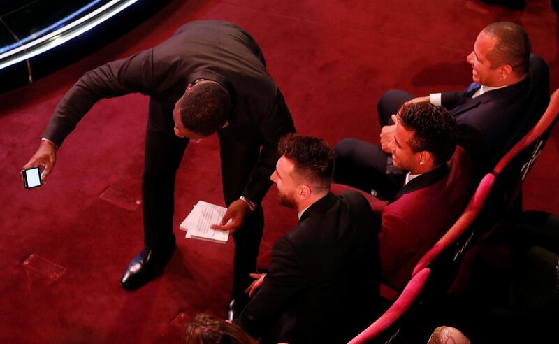 Actor Idris Elba takes a selfie with Barcelona’s Lionel Messi and Paris Saint-Germain’s Neymar during the awards. Eddie Keogh / Reuters