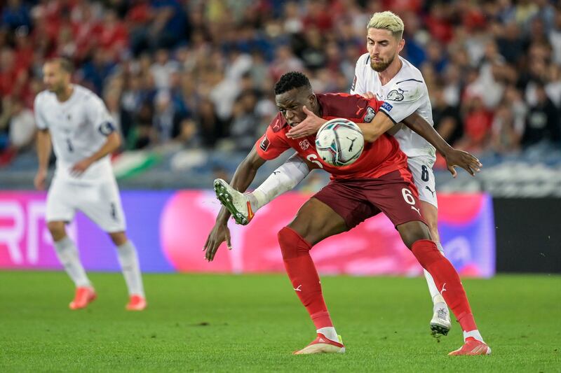 Switzerland's Denis Zakaria, left, fights for the ball against Italy's Jorginho. AP