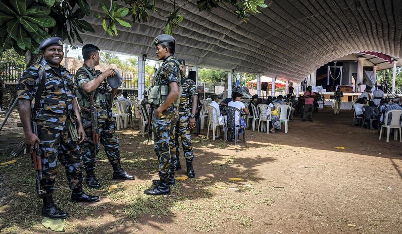 Security officers at a tent prepared for victim memorials at St Sebastian’s Church in Negombo, Sri Lanka, April 23, 2019. Jack Moore / The National. 
