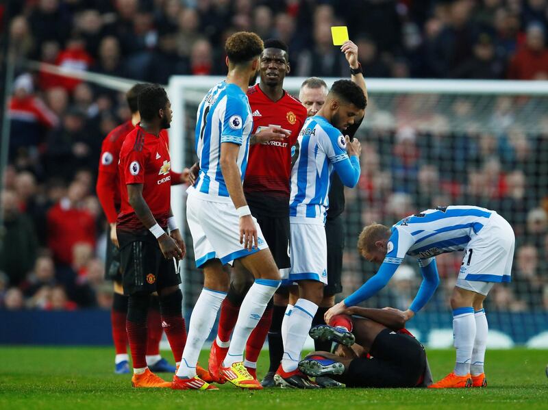 Huddersfield Town's Elias Kachunga is shown a yellow card by referee Jonathan Moss. Action Images via Reuters
