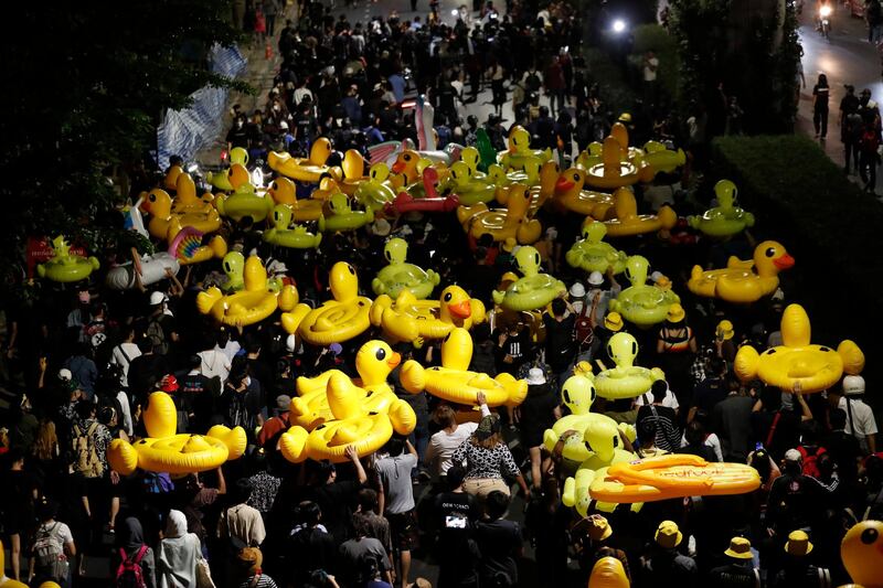 Protesters carry inflatable yellow ducks, which have become good-humoured symbols of resistance during anti-government rallies, while marching towards the base of the 11th Infantry Regiment, a palace security unit under direct command of the Thai king in Bangkok, Thailand. Pro-democracy demonstrators are continuing their protests calling for the government to step down and reforms to the constitution and the monarchy, despite legal charges being filed against them and the possibility of violence from their opponents or a military crackdown. AP Photo